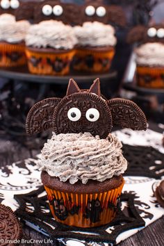 cupcakes with oreo cookies and frosting in the shape of a bat