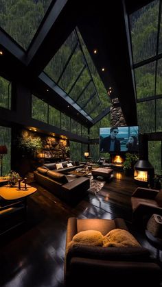 a living room filled with lots of furniture under a skylight next to a flat screen tv