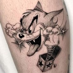 a tattoo on the leg of a man with a cartoon character