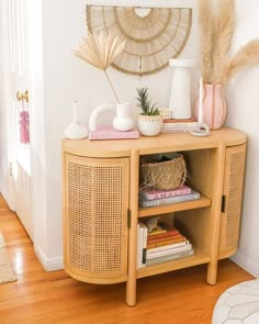 a shelf with books and vases on top of it