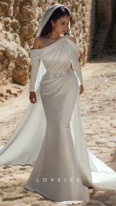 a woman in a wedding dress walking down the street