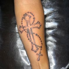 a person with a cross tattoo on their foot