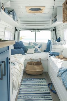 the inside of a camper with blue and white decor