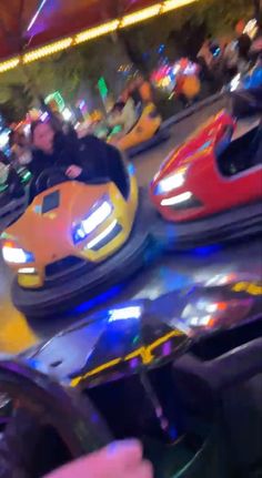 people riding bumper cars at an amusement park