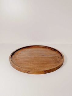 a wooden plate sitting on top of a white table