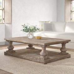 a living room with a white couch and wooden coffee table