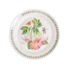 a white plate with pink flowers and butterflies on the rim, against a white background