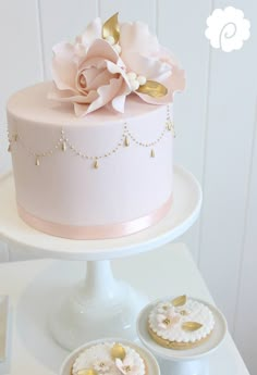 a pink cake sitting on top of a white table