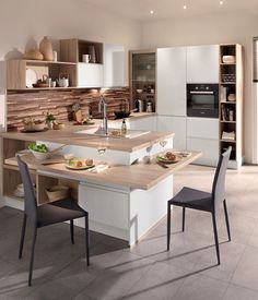 a kitchen with an island and chairs in it