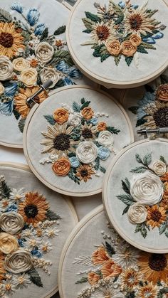 several different types of embroiderys with flowers on them are laid out in rows together