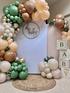 a baby shower is decorated with balloons and greenery for the entrance to its room