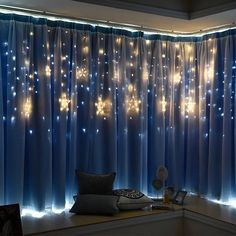 a window with blue curtains and lights on it