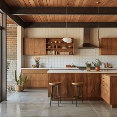 an open kitchen with wooden cabinets and stools