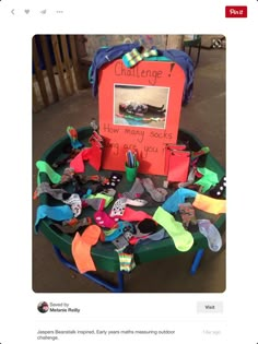 a green table topped with lots of different types of shoes and socks on top of it