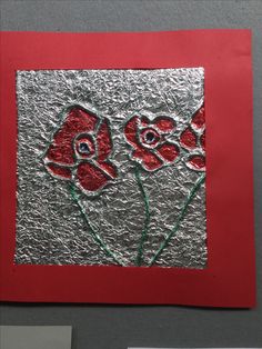 a piece of tin foil with red flowers on it