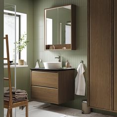 a bathroom with a sink, mirror and towel rack