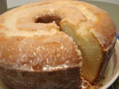 a bundt cake on a plate with one slice cut out