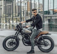 a man is sitting on a motorcycle in the street