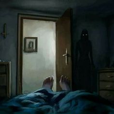 a person laying in bed with their feet up on the door way to a dark room