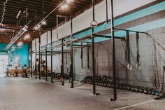 an empty gym with rows of exercise equipment