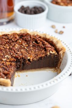 a chocolate pecan pie on a white plate