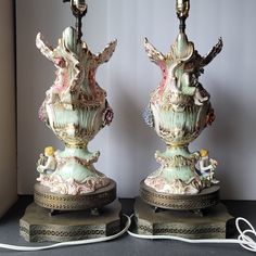 two decorative lamps sitting on top of a table