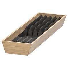 a wooden box filled with lots of black paper