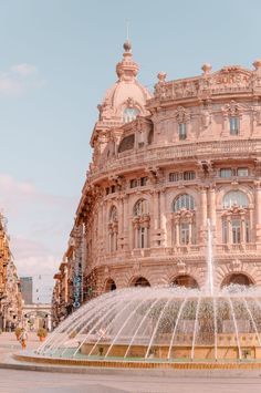 a large building with a fountain in front of it