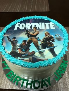 a birthday cake with the image of fortnite on it