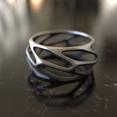 Introducing our Parametric Design 925 Sterling Silver Ring, a piece that embodies the fusion of art and mathematics. This ring is not just an accessory; it's a statement of modernity and innovation. The parametric design is a method of creating complex shapes and forms by using mathematical algorithms. Our ring captures this concept, showcasing intricate geometric patterns that are both visually stunning and intellectually stimulating. Handcrafted with 925 sterling silver, this ring is a testame Modern Titanium Ring, Ring Silver Men, Parametric Design, Men Ring, Ring Minimalist, Minimalist Ring, Diy Schmuck, Silver Gifts, Couple Rings