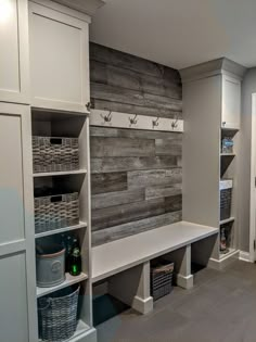 a room that has some shelves and baskets on the wall next to each other in it