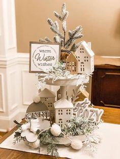 a white christmas tree on top of a wooden table