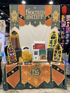 a table with many items on it at a trade show, including books and magazines