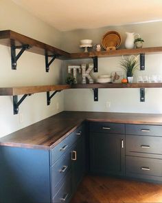 a kitchen with open shelving and wooden counter tops