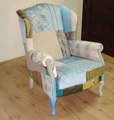 an upholstered chair sitting on top of a hard wood floor