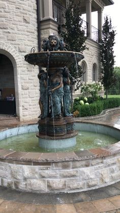 a water fountain in front of a large building