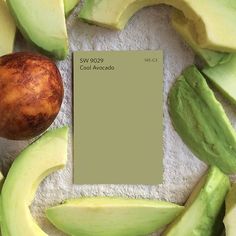 an avocado is shown next to a piece of paper with a color swatch