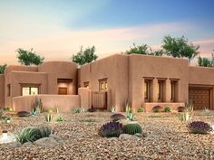 an adobe - style house with cactus and cacti in the front yard at dusk