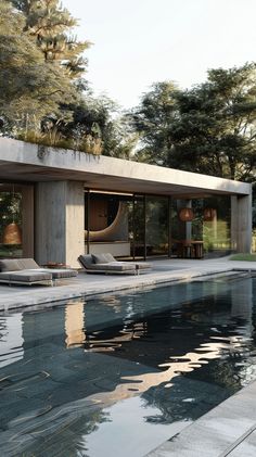 an outdoor swimming pool with chaise lounges next to it and trees in the background