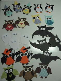 an assortment of owls and bats cut out from paper