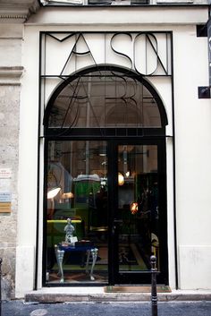 a store front with an arched glass window