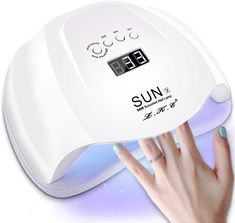 a woman's hand is pressing the button on an automatic sun nail dryer