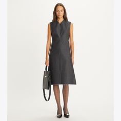 From the Fall ’24 runway. An architectural take on the shift dress made in crisp cotton denim. The sleeveless silhouette has a nipped waist, high V-neck and trapezoidal skirt. The square hem holds its shape through a bonding technique that adds dimension without weight, while the seams are raw-cut and heat-sealed for an elegantly undone look. Tory was inspired by the geometry of a humble lampshade. “We were thinking about making the everyday sublime,” she says. Hooded Wool Coat, Jersey Wrap Dress, Fall 24, Goddess Dress, The Shift, Tory Burch Miller, New Fragrances, Ladies Dress Design, New Handbags