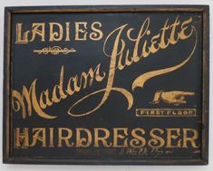 an old fashioned sign advertising ladies's hairdressers in gold and black