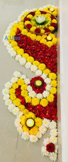 flowers and candles are laid out on the floor to be used as decorations for an event