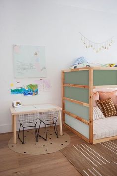 a child's bedroom with bunk beds, desk and rugs on the floor