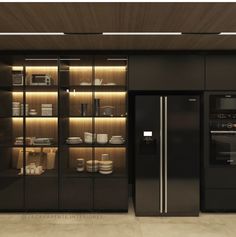 a modern kitchen with black cabinets and stainless steel appliances, along with built - in shelving