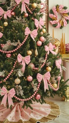 a decorated christmas tree with pink bows and ornaments