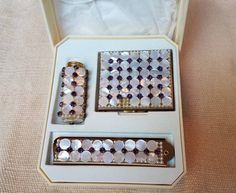 "Beautiful and Stunning one of a kind  vintage makeup case by Wiesner of Miami! This makeup kit comes with a gorgeous pearl powder compact, pearl lipstick case with a matching tortoiseshell comb. These items are bedecked with flat pear deco and deep purple rhisnstones. There is one pearl missing from the compact (see photo) This is a great piece for the collector! An amazing unforgettable gift for that loved one ♥️ DESIGNER WIESNER OF MIAMI  CIRCA 1950'S Power  2.8\" Lipstick 2\" Comb 4\" This is a stunning piece from the ESTATE OF LILA COCKRELL, former mayor of San Antonio, Texas, of who was instrumental in bringing the anglo and hispanic community together. She was such an amazing humanitarian and loved by all the community. Warm and genteel on the outside, she was a \"no-nonsense negoti Elegant Compact Case With Included Case, Elegant Compact Case, Pearl Lipstick, Vintage Makeup Train Case, Vintage Makeup Compact, Velvet Glove, Vintage Mirror Compact, Vintage Statues, Compact Mirror Personalized