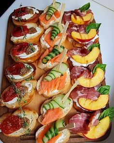 an assortment of appetizers are displayed on a cutting board